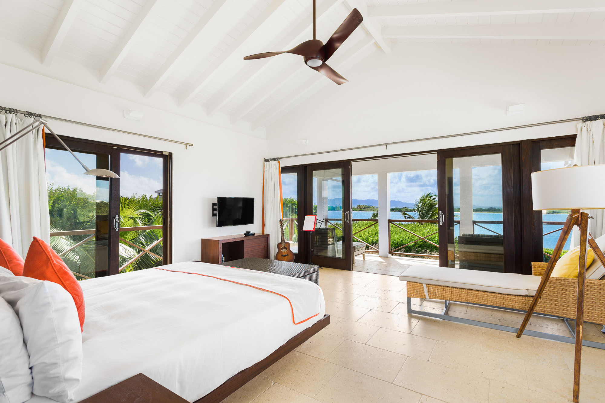 Bedroom suite with terrace doors and water views